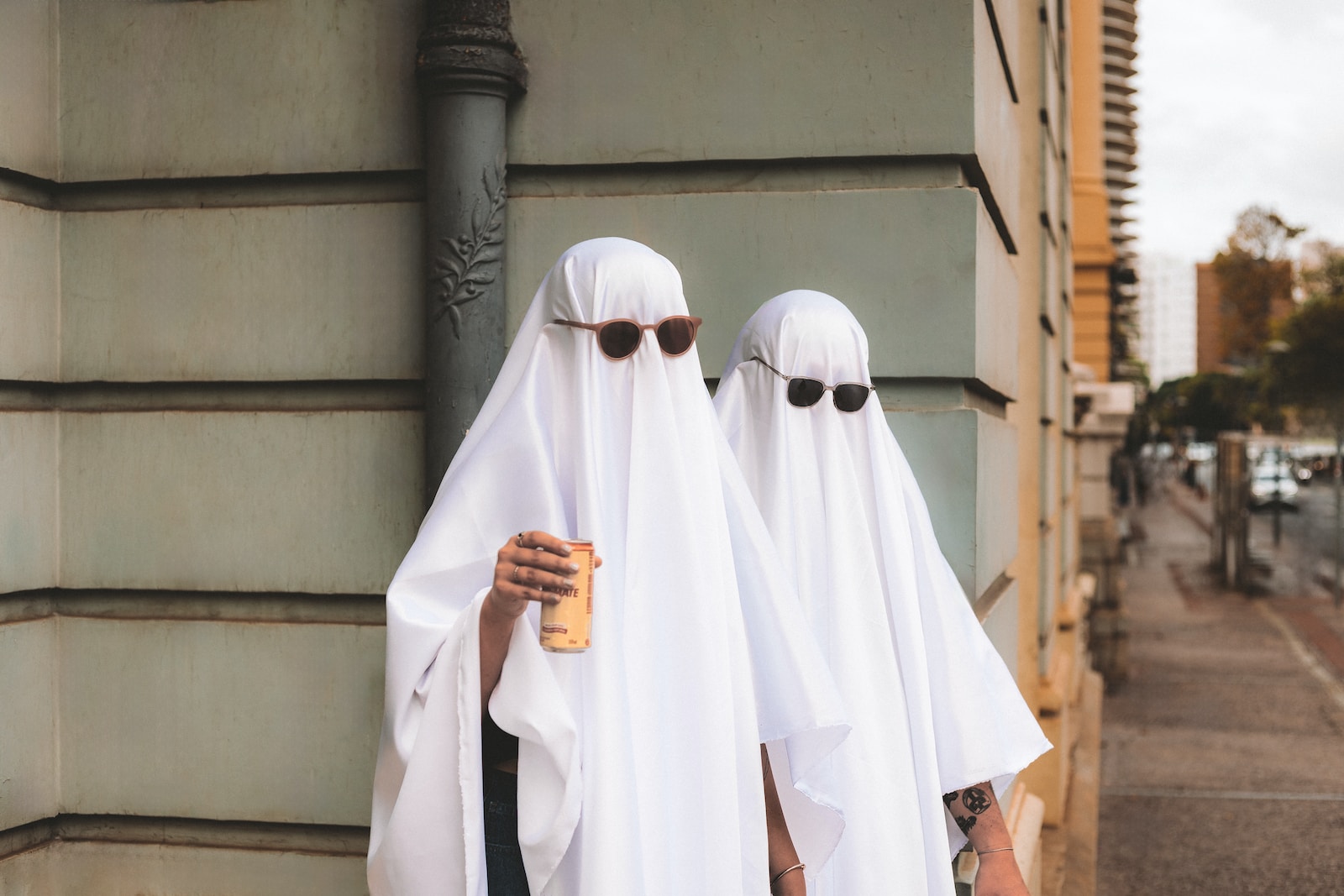 two people dressed in white standing next to each other